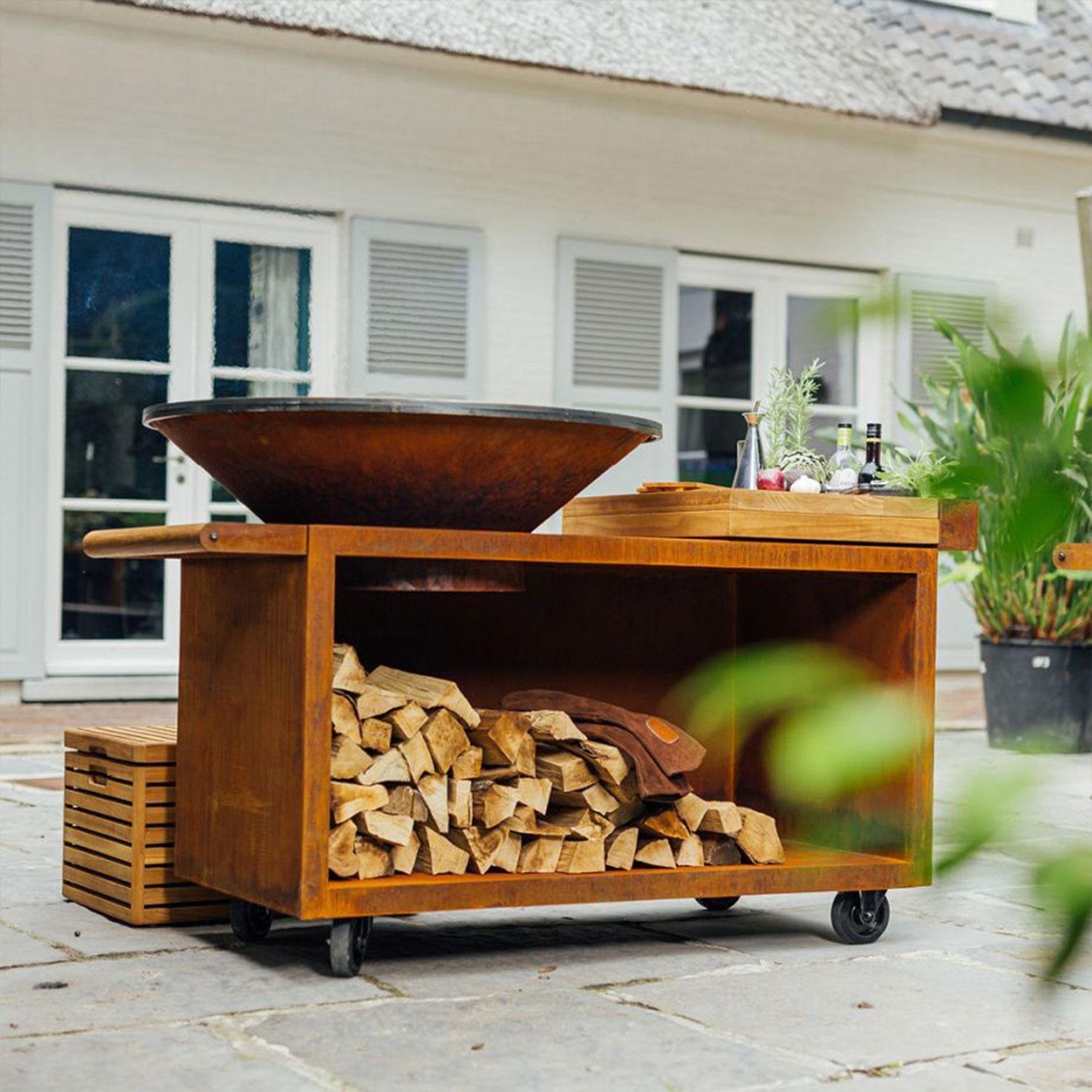 OFYR OI-100-PRO-TW Island Corten 100 PRO Teak Wood 70 Inch Wood-Fired Grill Center - Back Patio - Styled w/ Wood Insert (Not Included) - Lifestyle thumbnail