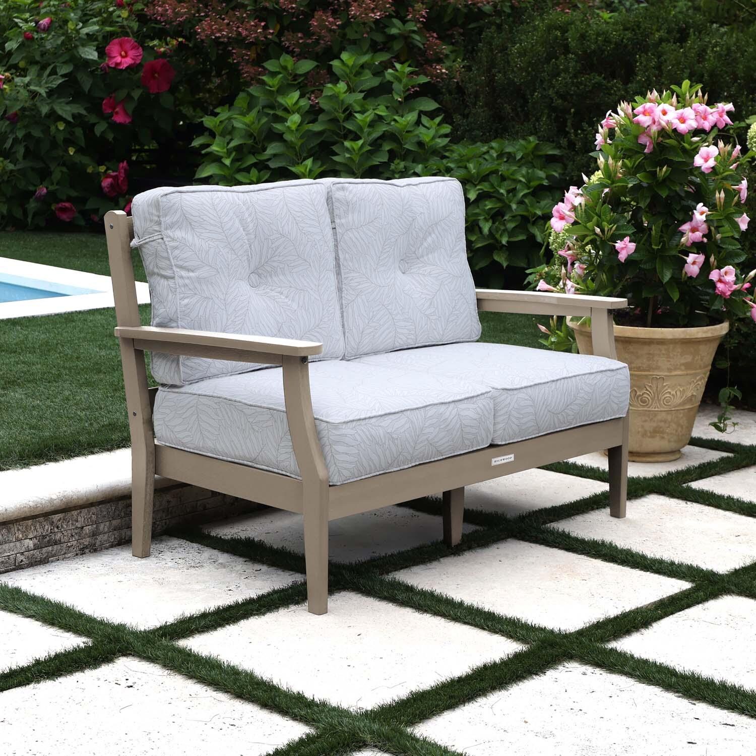 Blushing Bay 2 Person Recycled Plastic Loveseat in Lively Parchment/Woodland Brown by Lakeview Outdoor Designs - Left Angled - Lifestyle thumbnail