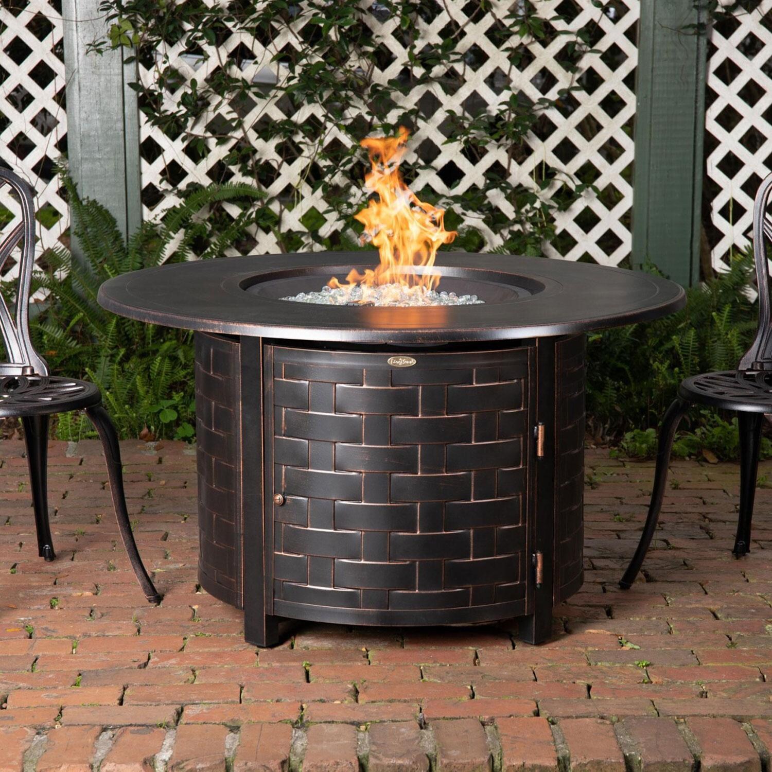 Ultimate Patio Magnolia Way 50,000 BTU Propane Round Fire Pit Table - Woven Cast Aluminum - In Use - Lifestyle thumbnail