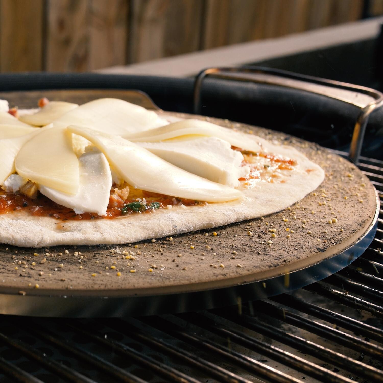 BBQGuys Signature BBQ-KPZ-16 Ceramic Pizza Stone With Stainless Steel Carry Rack - In Use thumbnail