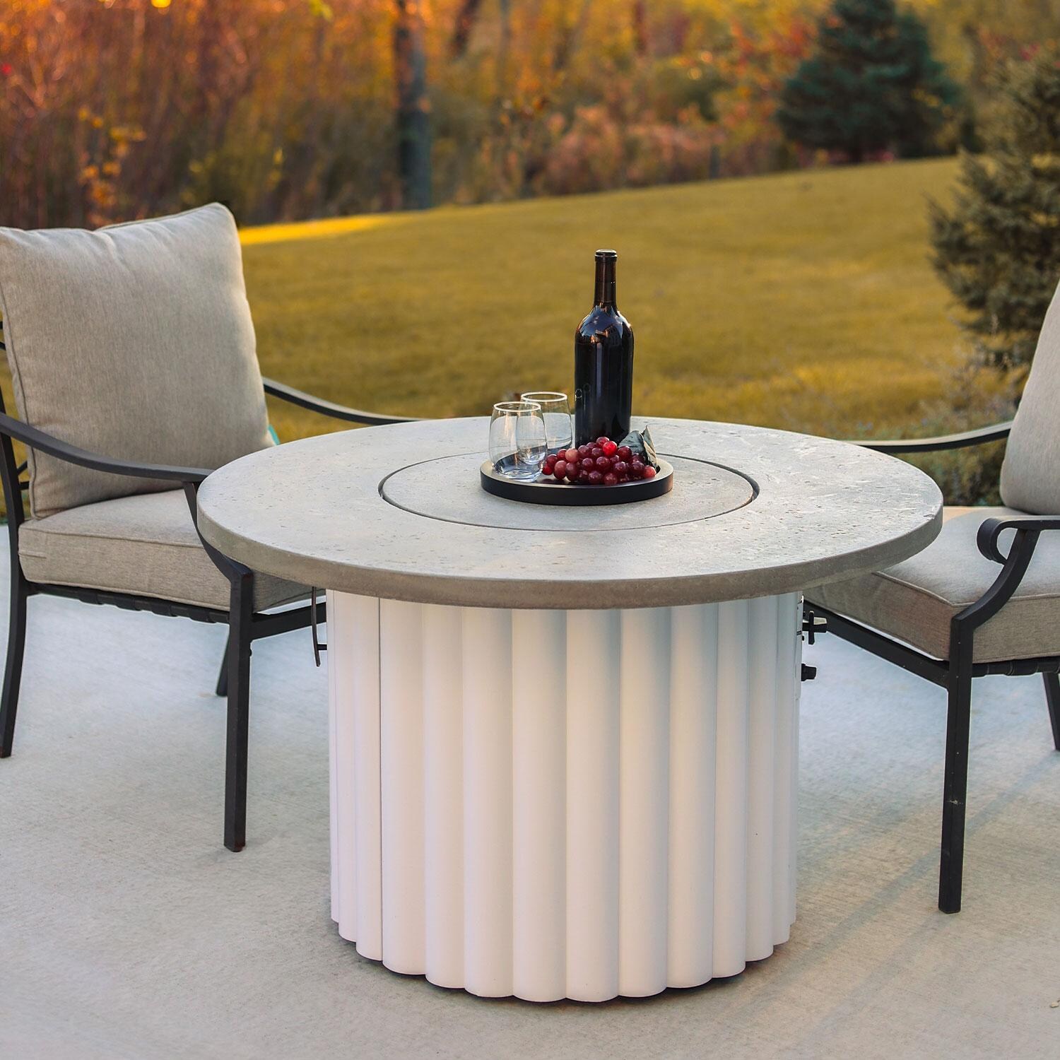 Reverie REVRWH-42-K-NG 42-in Round Aluminum Natural Gas Aluminum Fire Pit Table w/ Relic Grey Supercast Top & White Base (Ships Propane w/ Conversion Kit) - Cover On - Lifestyle thumbnail