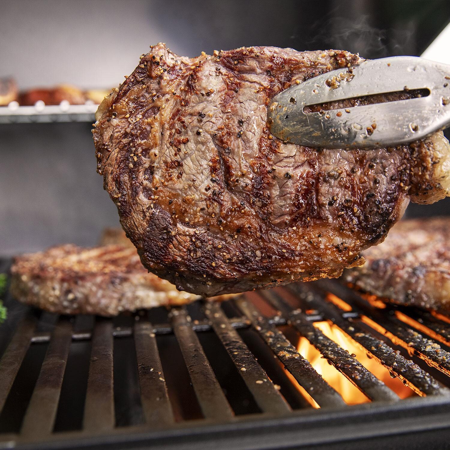 Weber GENESIS 1500011 E-315 Propane Grill - Black - Steak Cooked Through - Lifestyle