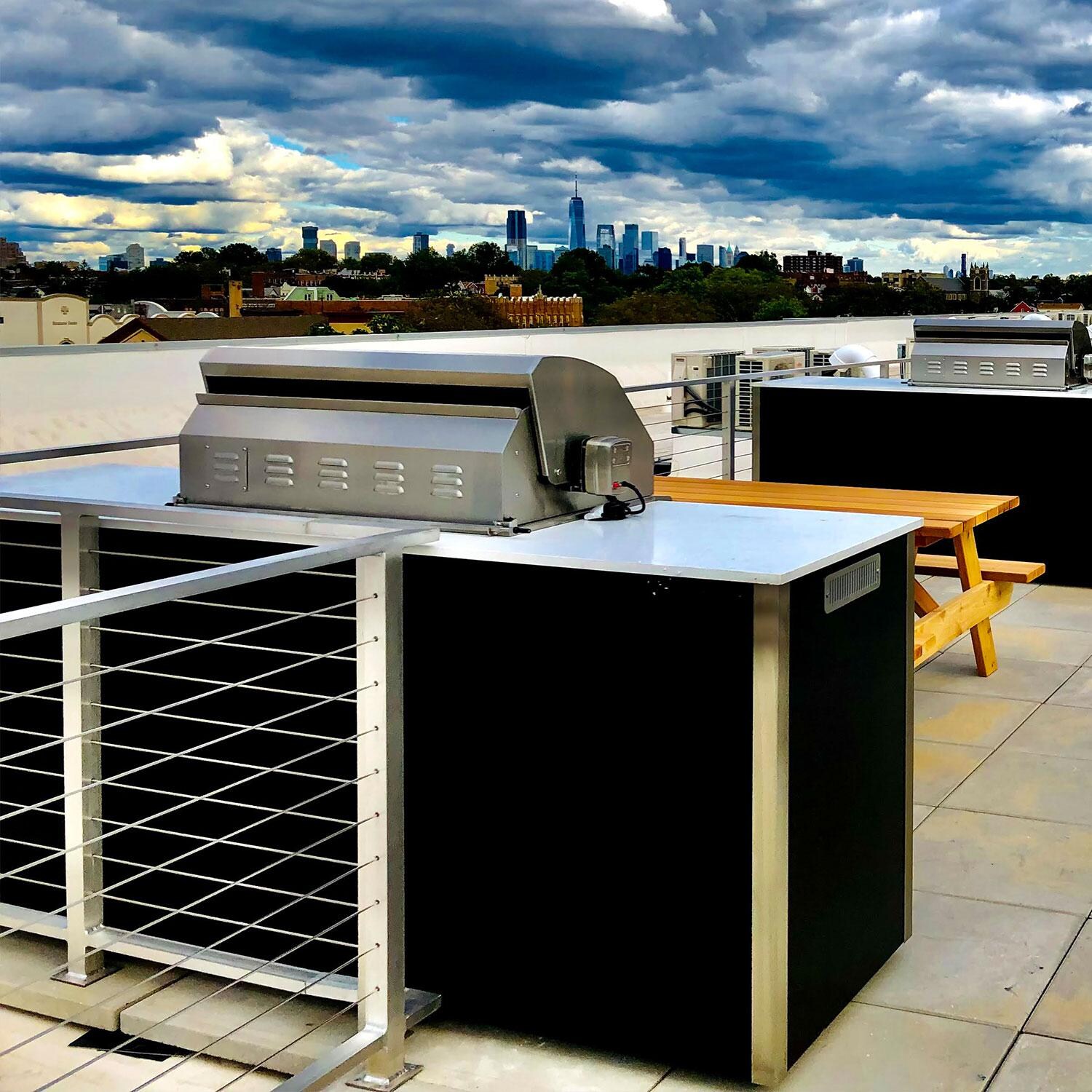 XO Designer 8 1/2 Ft Outdoor Kitchen Island w/ 36-in Natural Gas Pro-Grade Grill, Door & Drawer, Trash Drawer & Outdoor Refrigerator in White - Rear View - Shown in Black finish - Lifestyle thumbnail