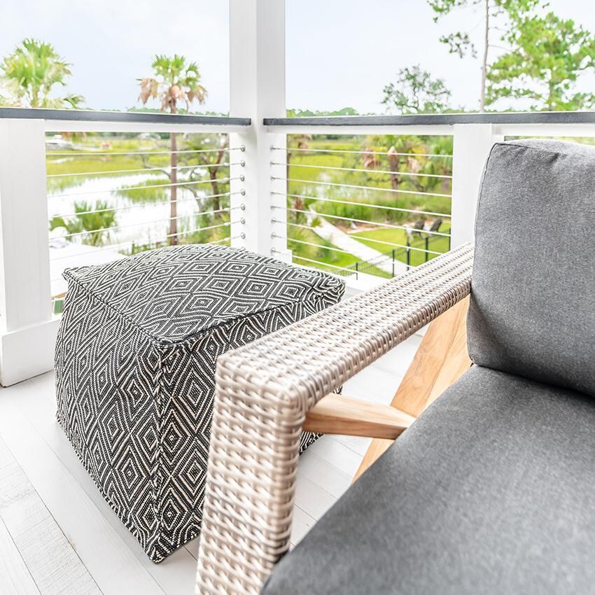 Teak + Table Caicos Sofa in Natural - Landscape (Carbon Cushions Shown) - Lifestyle thumbnail