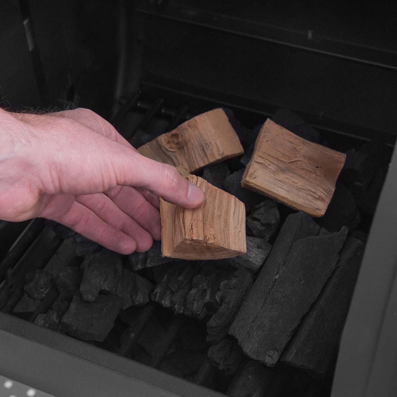 Broil King 958050 Regal Charcoal Offset 500 Smoker - Adding Wood Chunks - Lifestyle thumbnail