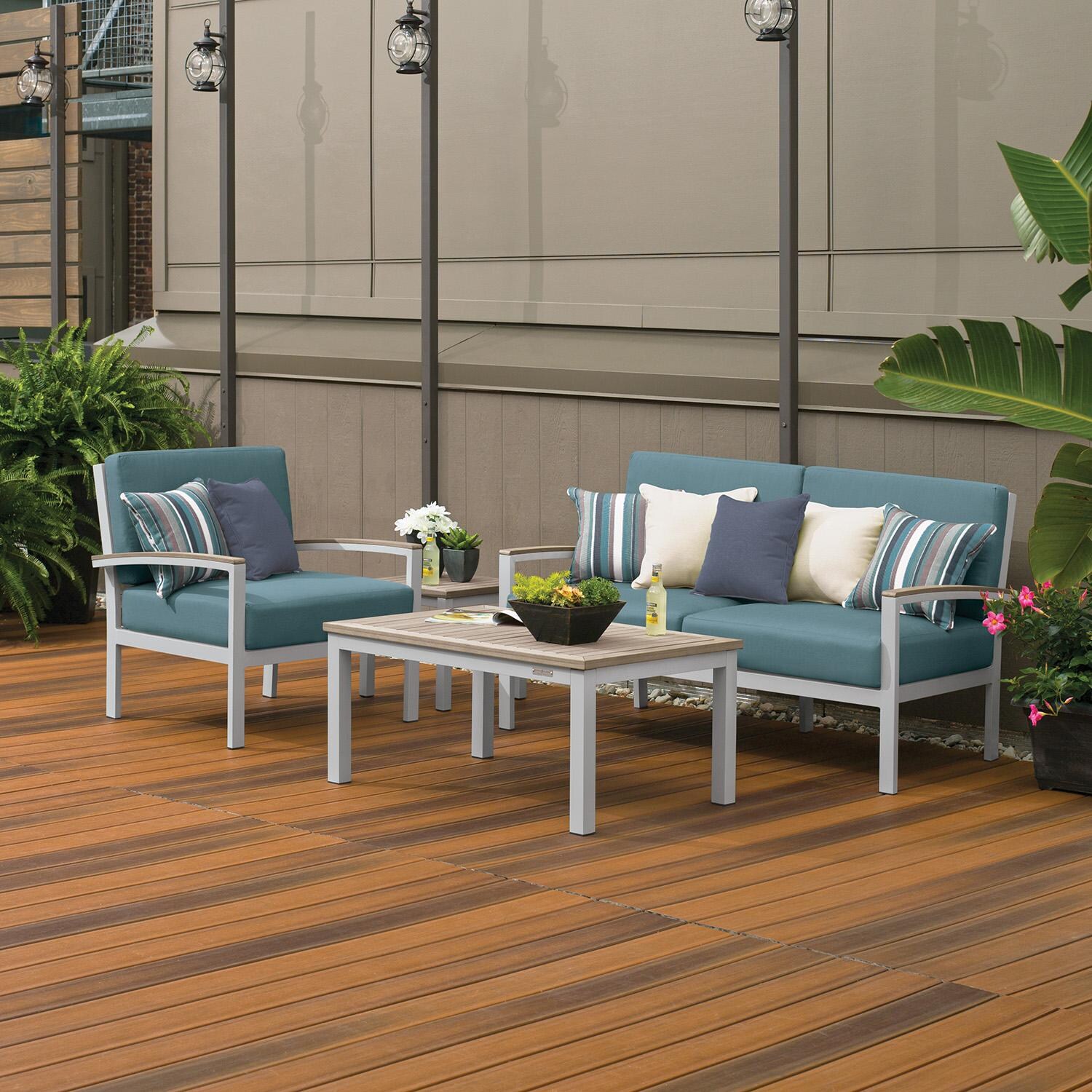 Oxford Garden 5268-PC.F Travira 4 Pc Aluminum Seating Set w/ Club Chair in Vintage Tekwood/ Ice Blue by Oxford Garden - On Patio by Fireplace - Lifestyle thumbnail