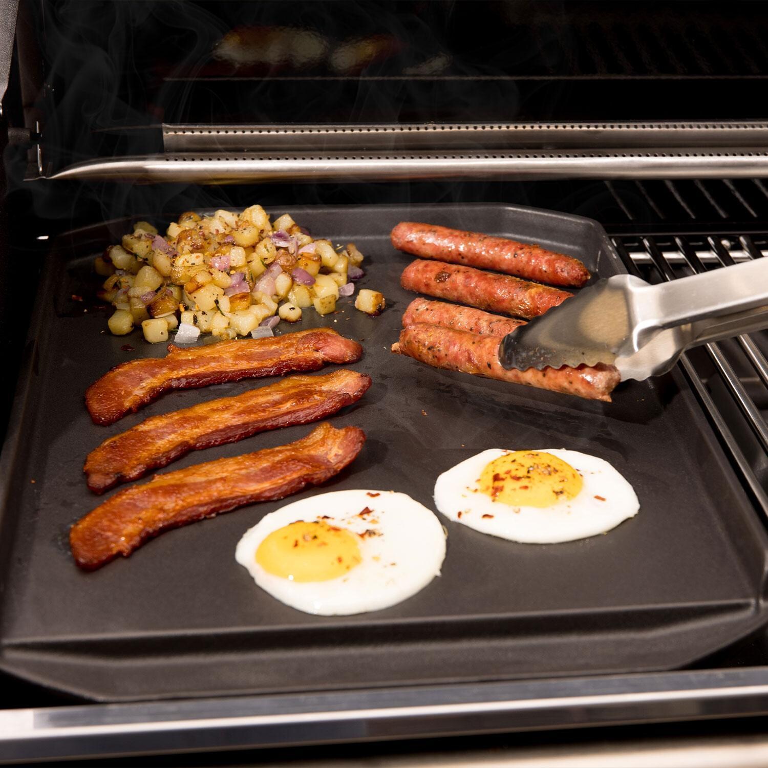 Broil King 11342 Cast Iron Plancha - Flipping Sausages - Lifestyle thumbnail