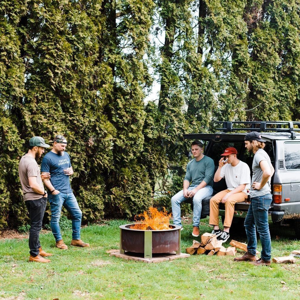 Breeo BR-X30P X Series 30 Inch Smokeless Round Corten Steel Wood Burning Fire Pit - In the Backyard with Friends - Lifestyle thumbnail