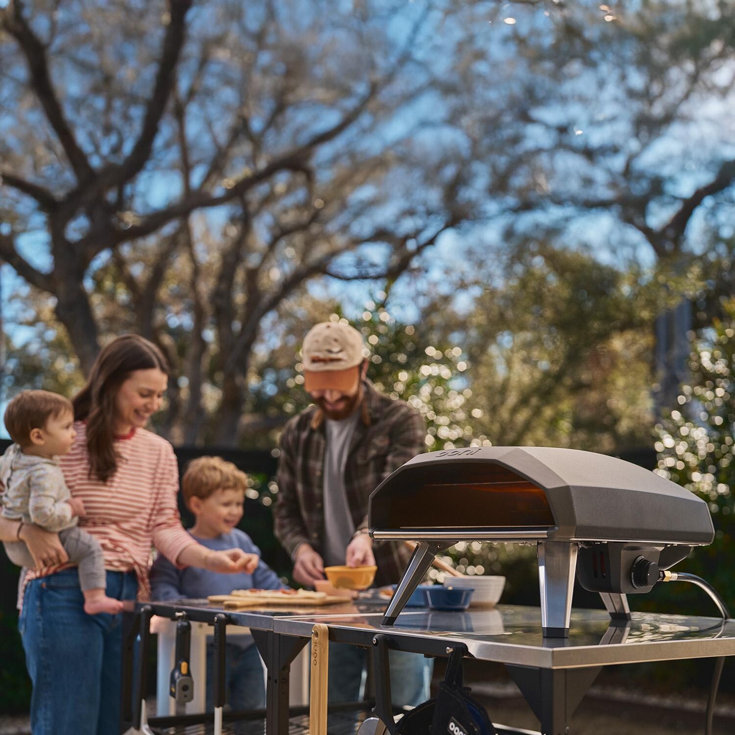 Ooni UU-P2D100 Koda 2 14 Inch Propane Portable Pizza Oven - Black - Eating w/ Family - Lifestyle thumbnail