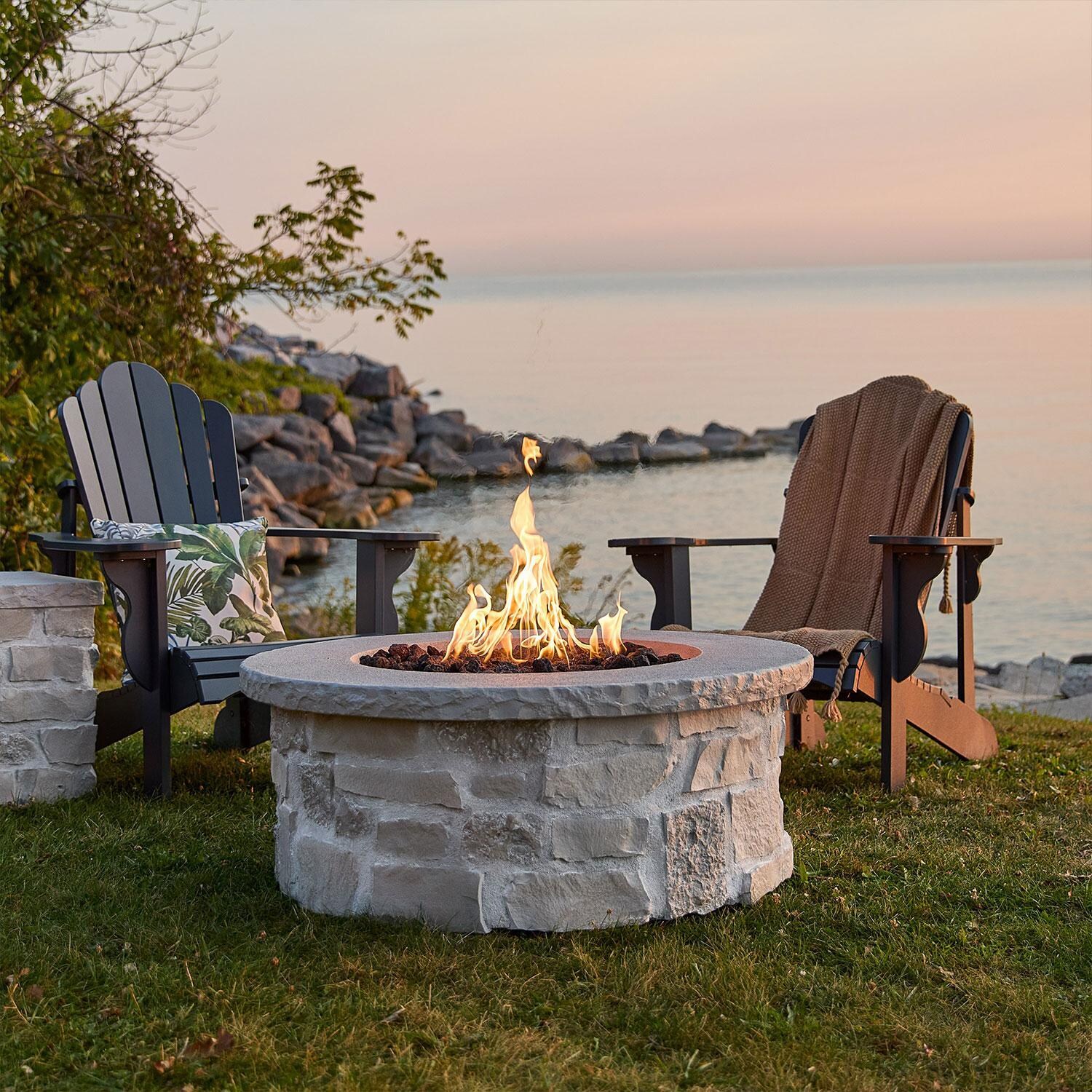 Heritage 40 Inch Round Stone Propane Fire Pit Table in Beige by Lakeview Outdoor Designs - Lakeside View - Lifestyle thumbnail
