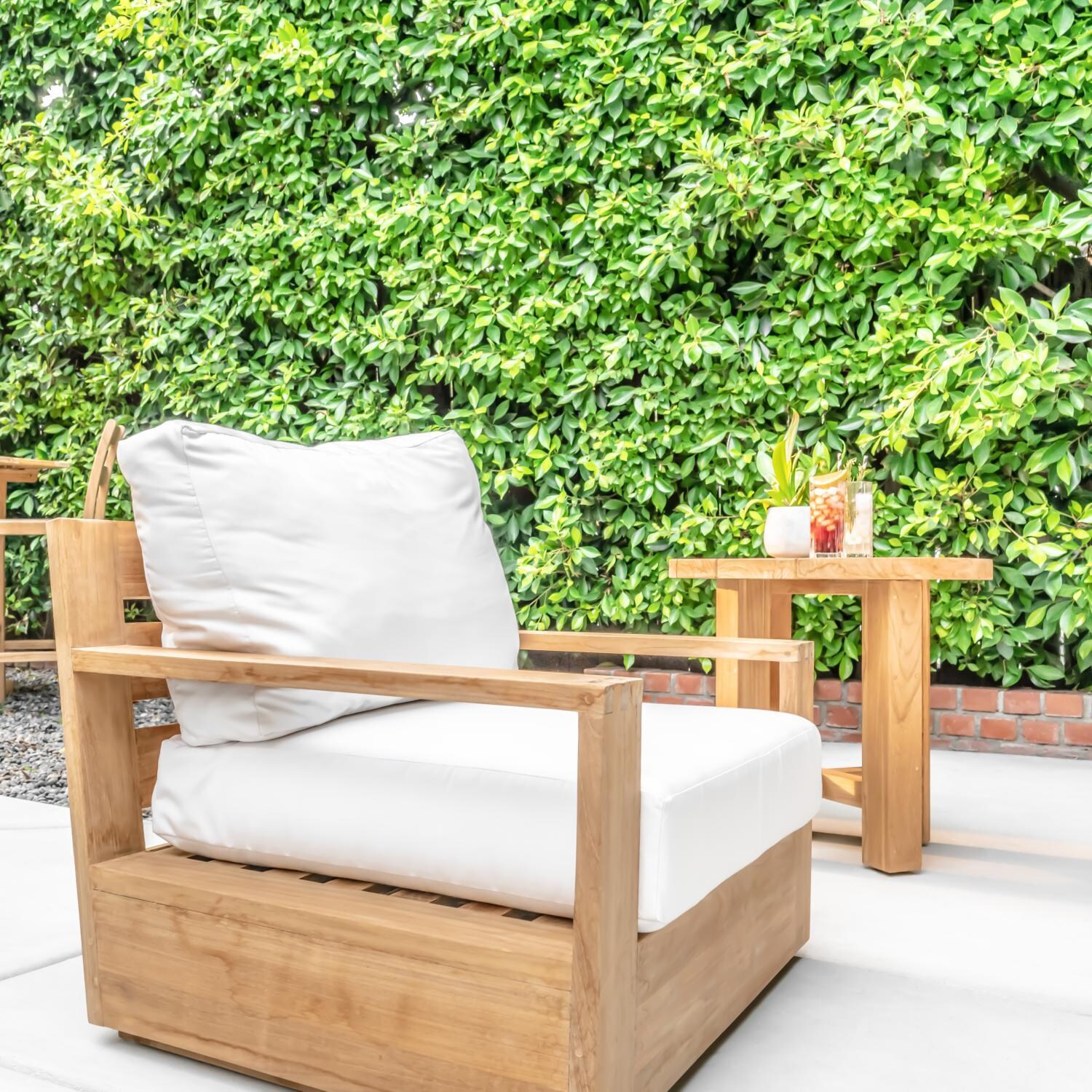 Teak + Table Atlantic Teak Patio Club Chair in Granite - Natural cushions shown - Lifestyle thumbnail