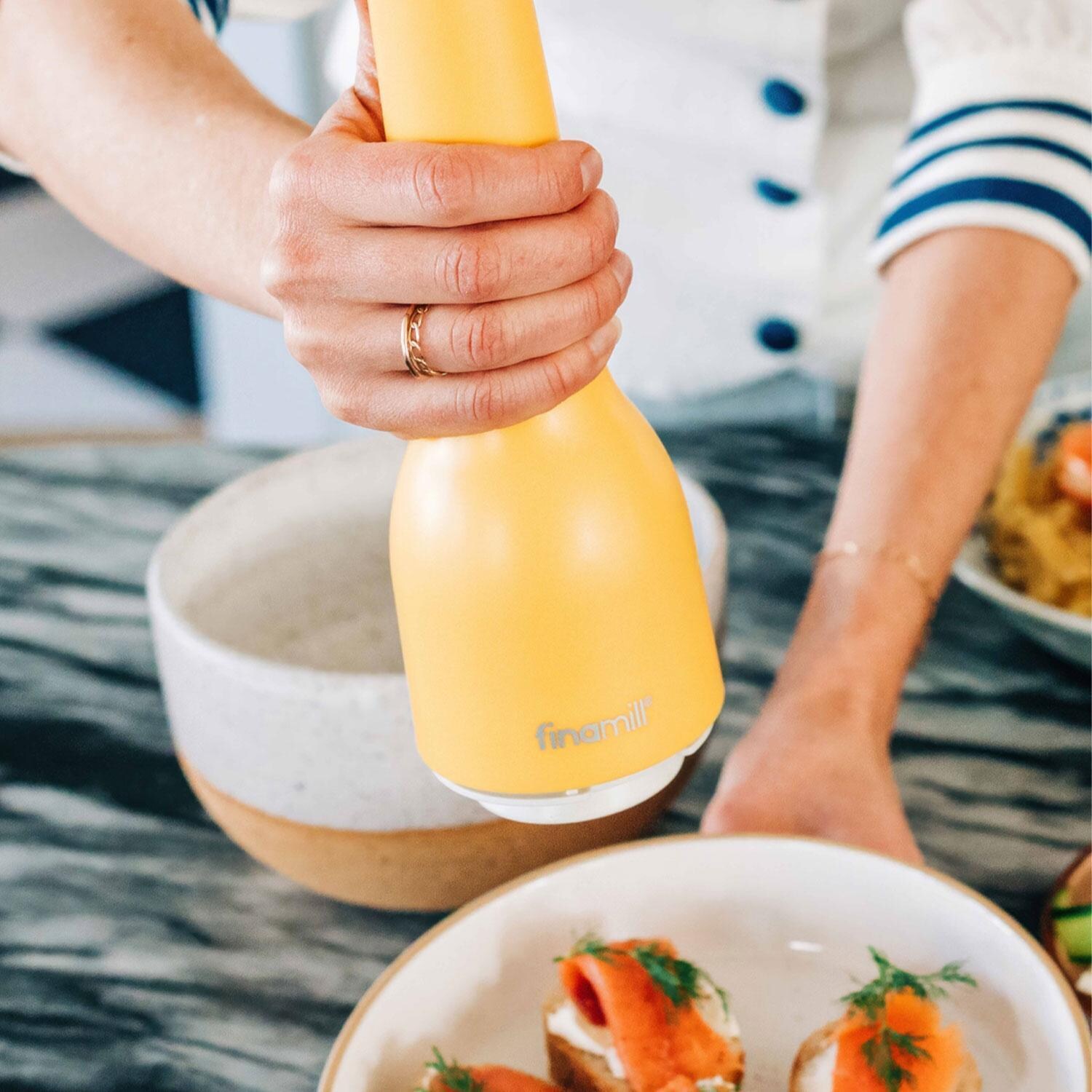 FinaMill GP813437-111CNY Classic Rechargeable Spice Grinder in Canary w/ 1 Everyday Pod & 1 Peppercorn Pod - In Use - Lifestyle thumbnail