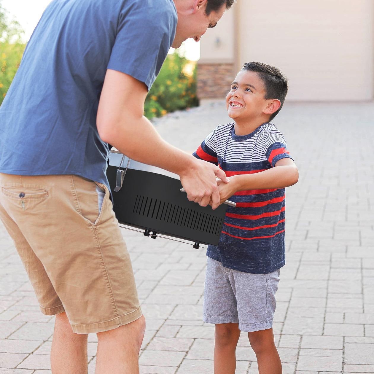 Everdure HBCUBEOUS CUBE 17-Inch Portable Charcoal Grill - Orange - Moving (Shown in Black) - Lifestyle thumbnail