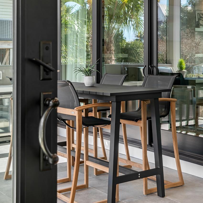 Teak + Table Capri Sling Bar Chair in Grey - Chairs on Patio - Lifestyle thumbnail