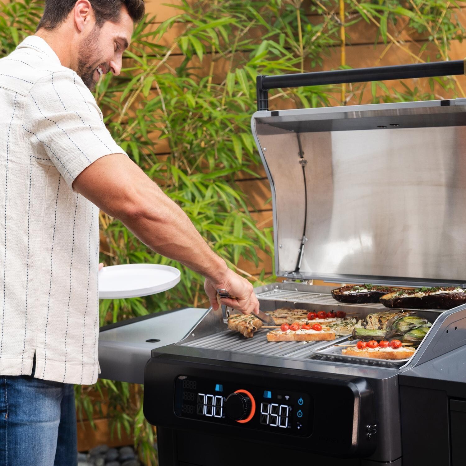 Current 24653014BC Model G Dual Zone Electric Grill W/ Cabinet in Black - Cooking Angled - Lifestyle thumbnail