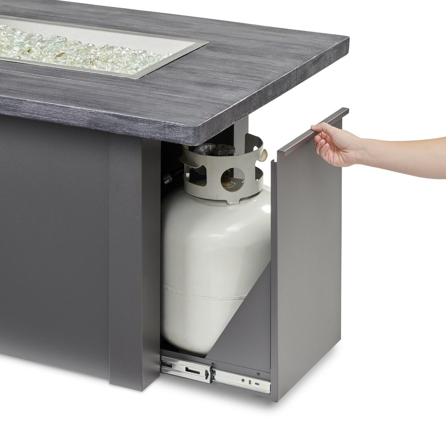Havenwood 62 Inch Propane Fire Pit Table W/ Carbon Grey Top & Grey Base - Hand Reaching For Tank Drawer - Detail thumbnail