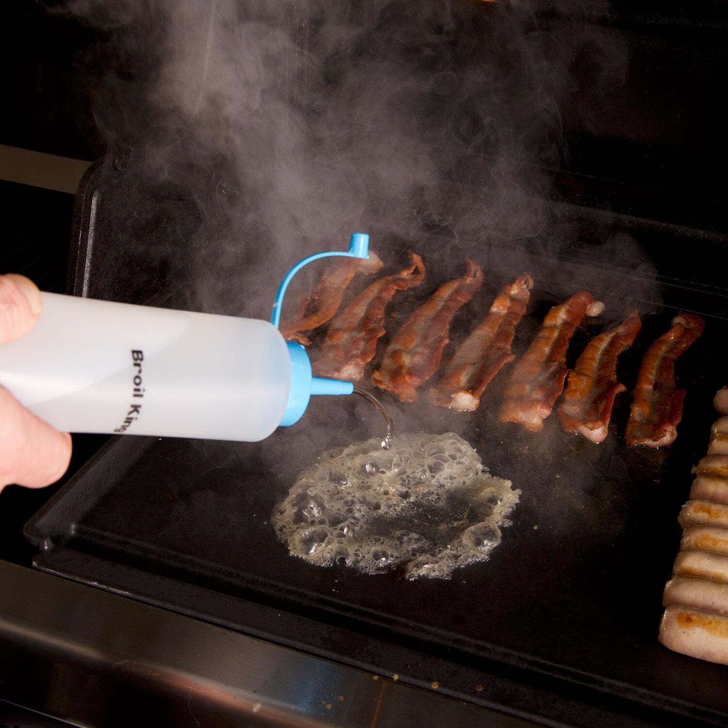 Broil King 11306 6 Pc Plancha Cooking Tool Set - Pouring Oil on Griddle w/ Squeeze Bottle - Lifestyle thumbnail