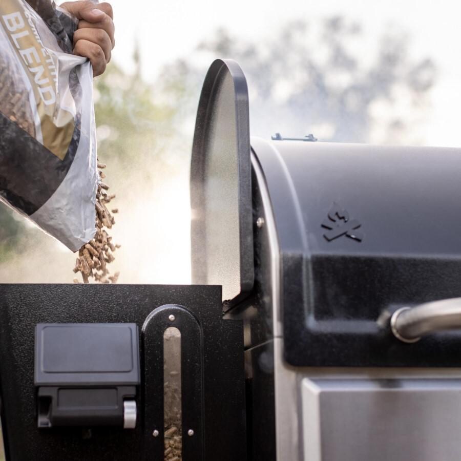 Camp Chef PG36WWSB + PG14 Woodwind Pro WiFi 36-Inch Pellet Grill With Propane Sidekick Griddle - Loading the Hopper - Lifestyle thumbnail