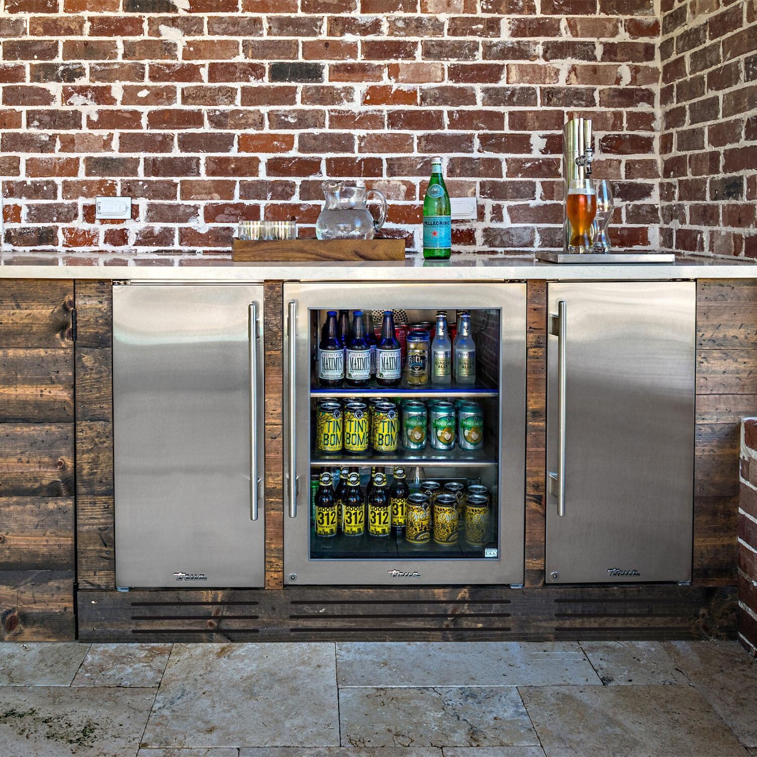 True TUIADA-15-RS-A~027-H04 ADA Height 15-Inch 75 Lb. Right Hinge Outdoor Ice Maker - Matte Black w/ Stainless Steel Handle - Installed in Island w/ Beverage Coolers - Lifestyle