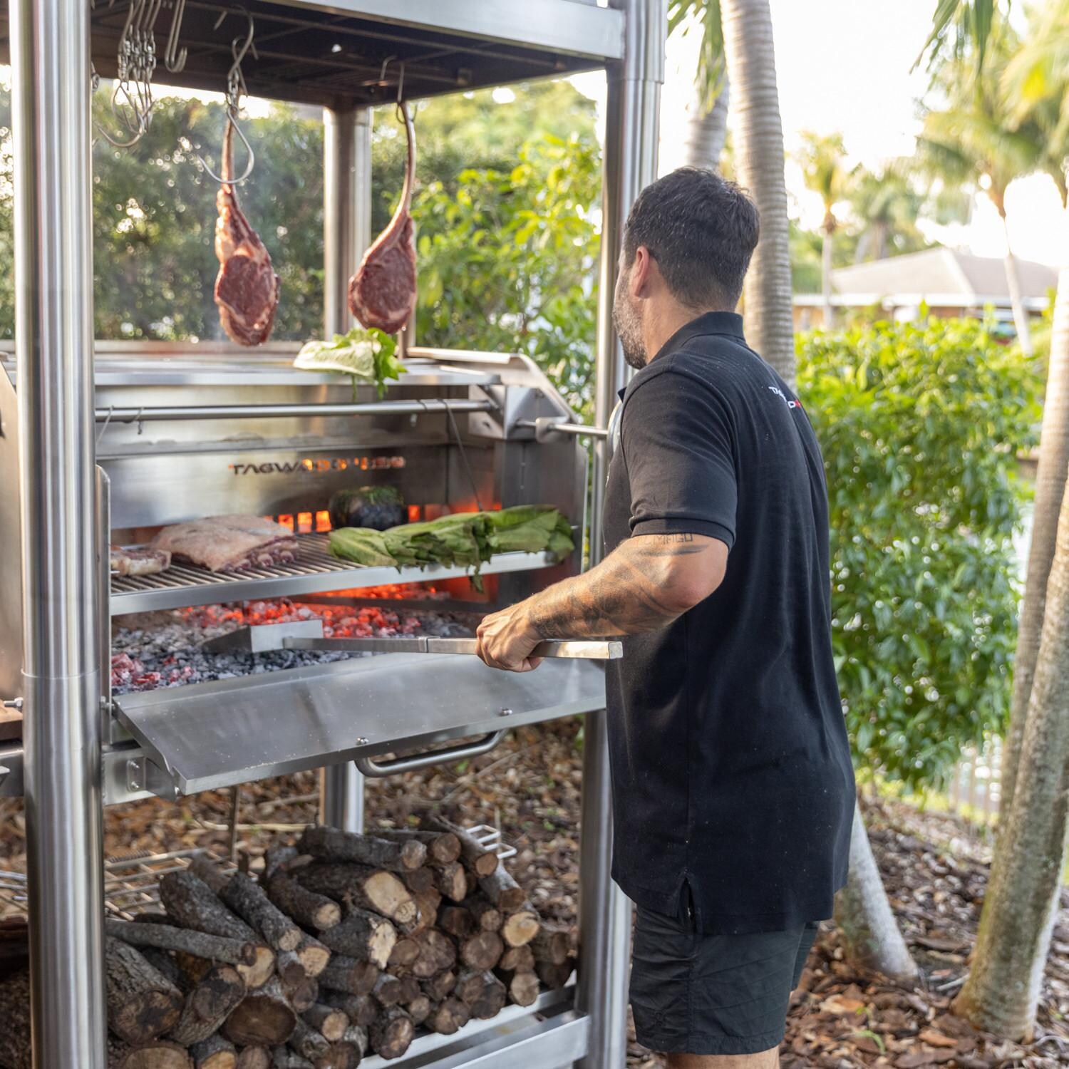 Tagwood BBQ02SS BBQ Silver Bullet All Stainless Steel Argentine Wood Fire & Charcoal Grill - In Use thumbnail