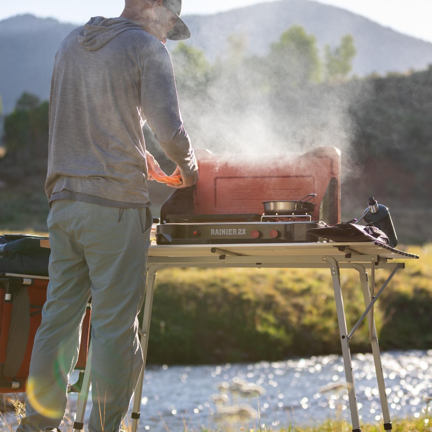 Camp Chef MSGGX Mountain Series Rainier 2X 2-Burner Cooking System w/ Griddle & Carry Bag - Set Up On Table thumbnail