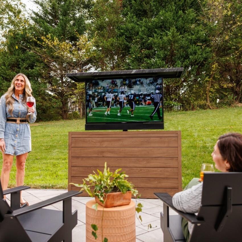 BBQGuys Signature 72 Inch 360 Degree Swivel Outdoor TV Lift Cabinet | Toffee w/ Black Granite - Watching the Game - Lifestyle thumbnail