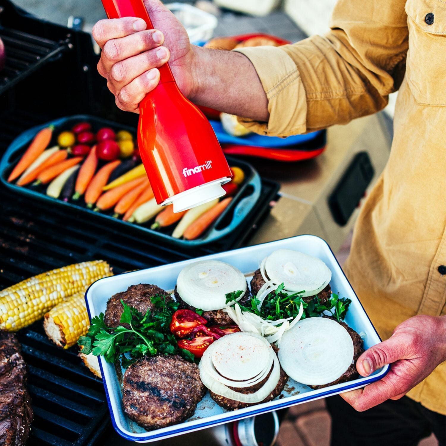 FinaMill GP803437-111SAN Classic Battery-Operated Spice Grinder in Sangria w/ 1 Everyday Pod & 1 Peppercorn Pod - In Use - Lifestyle thumbnail