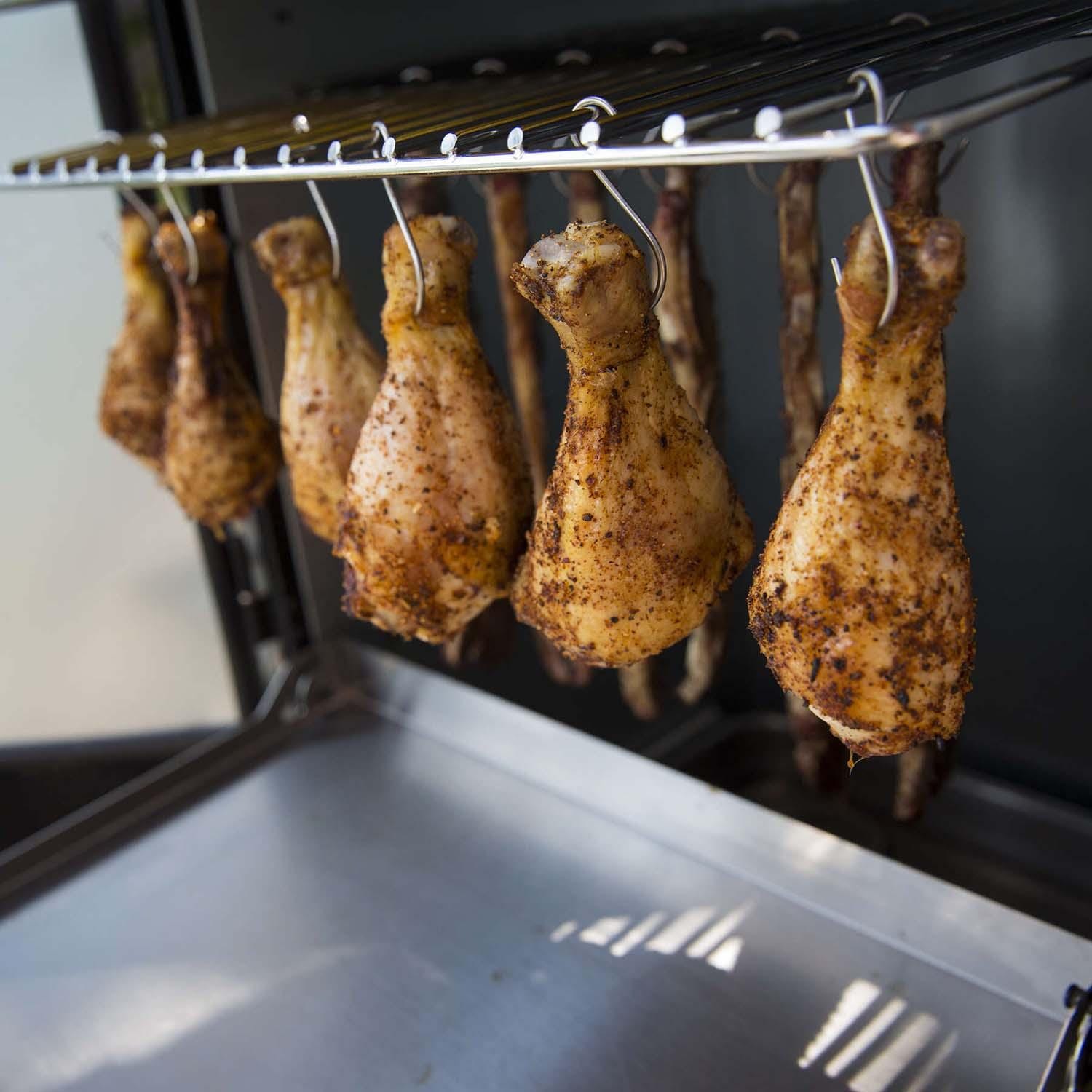 Broil King 28-Inch Smoke Vertical Charcoal Smoker - Black - Drumsticks on Hooks - Lifestyle thumbnail