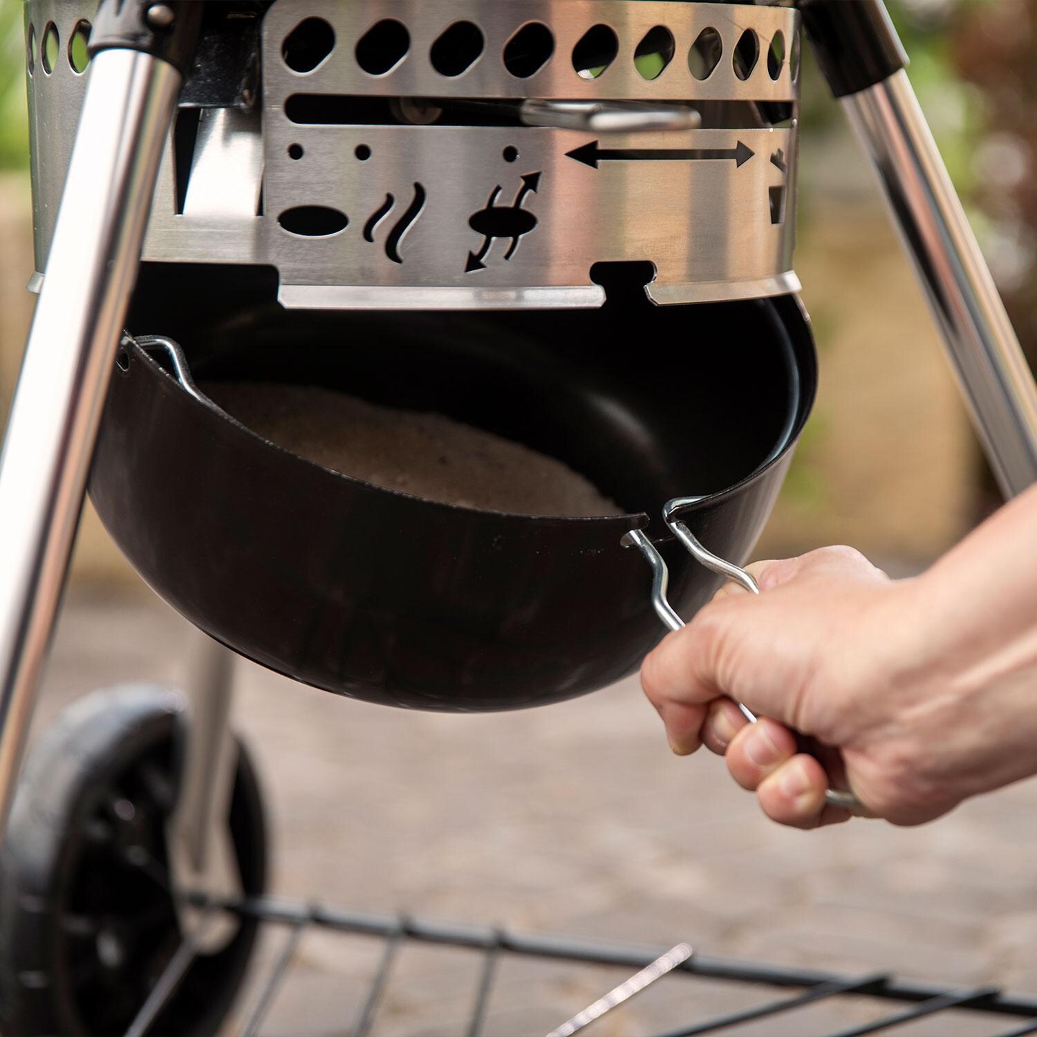 Weber 1500064 Master Touch 26-Inch Charcoal Grill With Gourmet BBQ System Cooking Grate in Black - Ash Catcher In Use - Interior - Lifestyle thumbnail