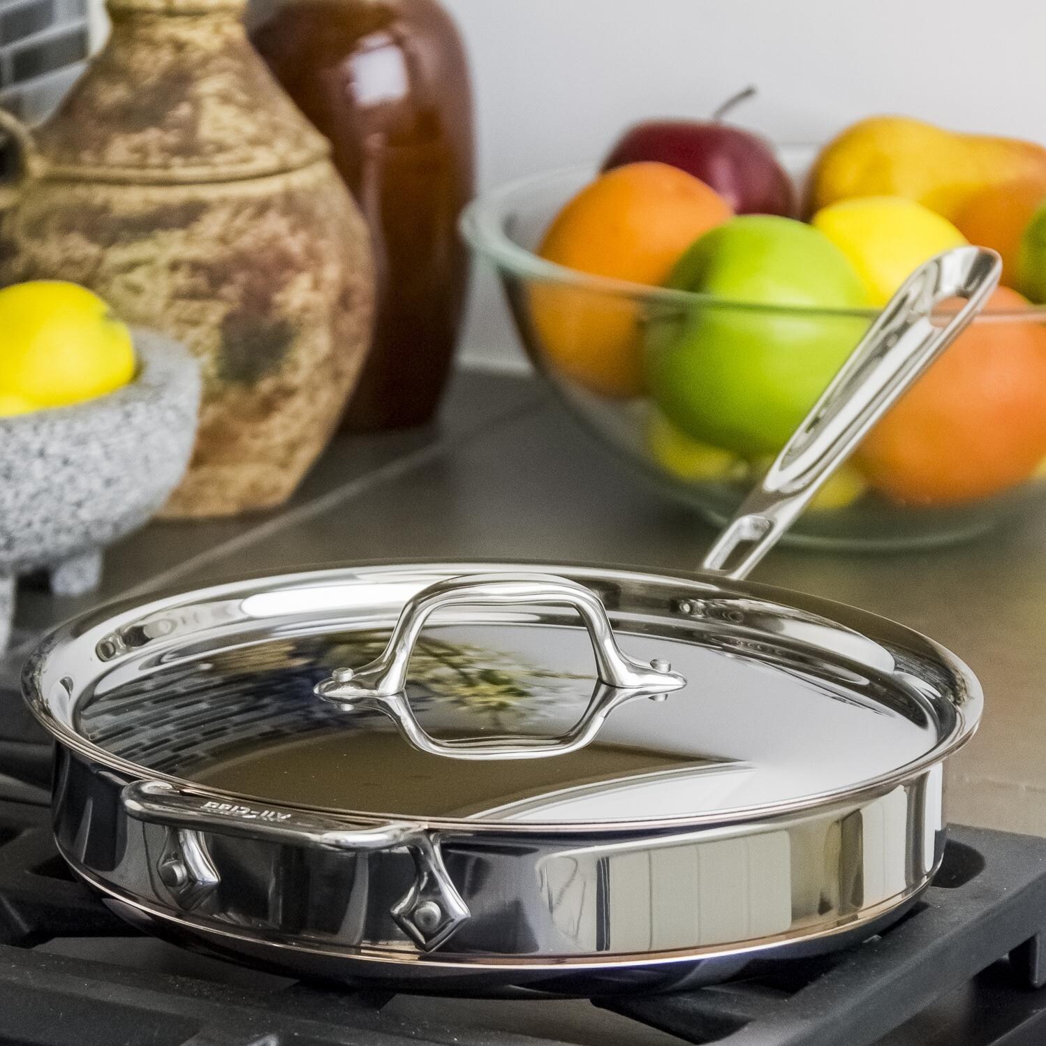 All-Clad Copper-Core 3-Quart Saute Pan With Lid In Use thumbnail