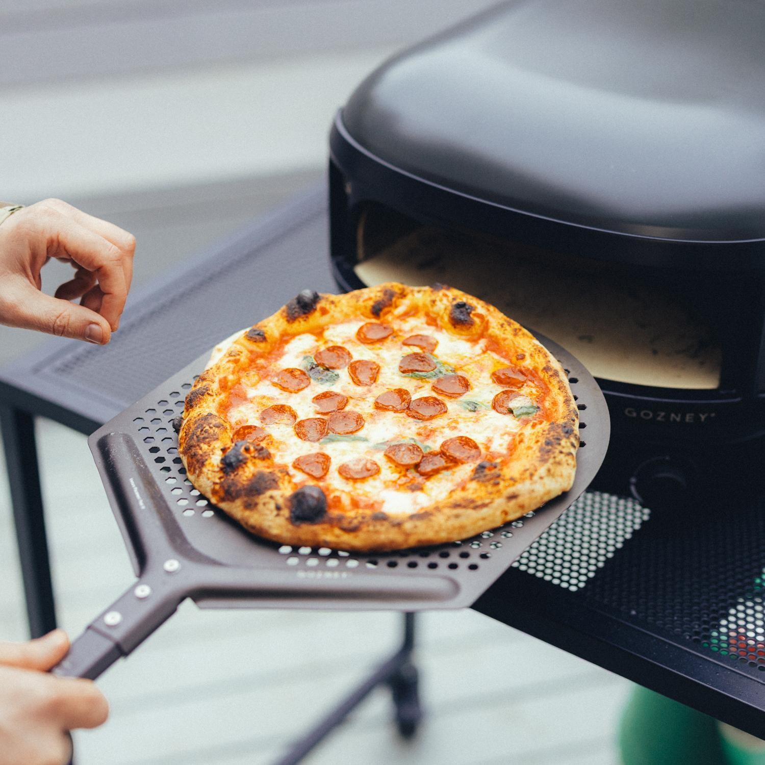 Gozney GAPOBUS1226 Black Arc Lite Propane Pizza Oven Bundle - Pizza on Peel - Lifestyle thumbnail