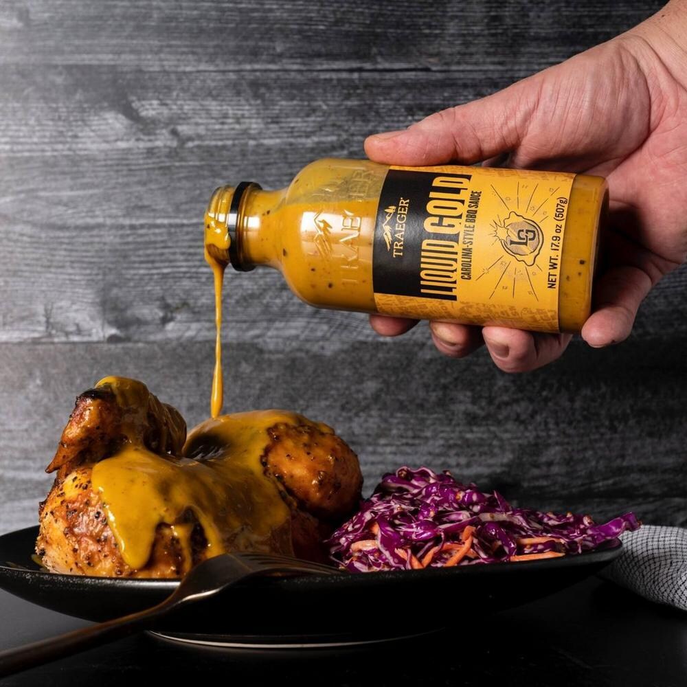 Traeger SAU049 Liquid Gold BBQ Sauce - Pouring on Chicken thumbnail