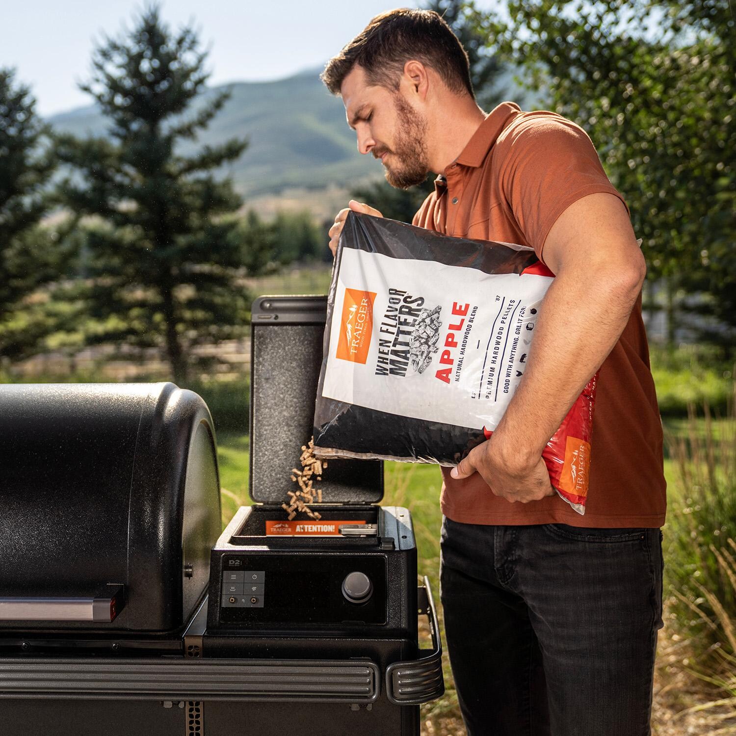 Traeger 20 Lb. Natural Hardwood Pellets - Apple - Pouring - Lifestyle thumbnail
