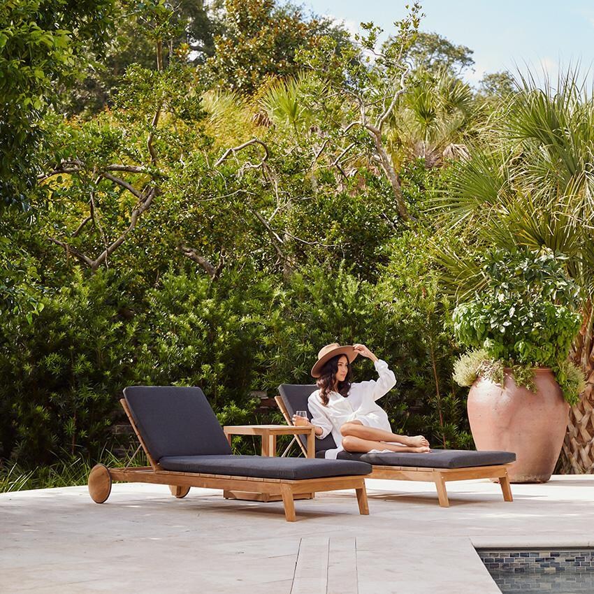 Teak + Table Capri Chaise Lounge in Natural - Relaxing on Chaise - Lifestyle thumbnail