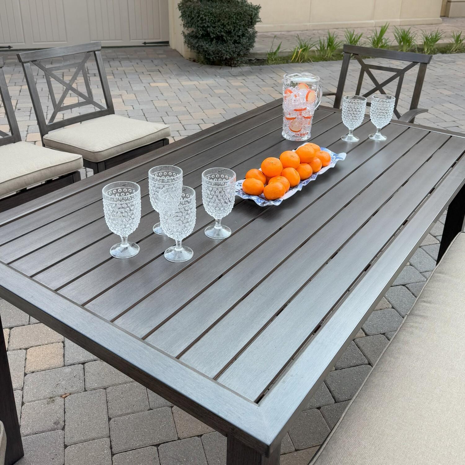 Atlantis 6 Pc Aluminum Dining Set w/ 2 Dining Side Chairs, 2 Swivel Rocker Dining Arm Chairs & Two Person Bench in Walnut/Beige by Darlee - Angled Table - Lifestyle thumbnail