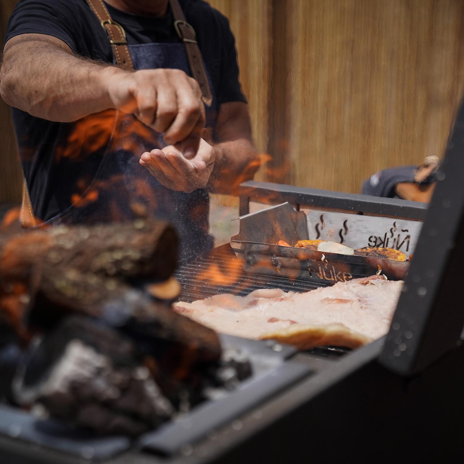 Nuke DELTA02 Delta 40-Inch Argentinian-Style Gaucho Grill - Seasoning Meat - Lifestyle thumbnail