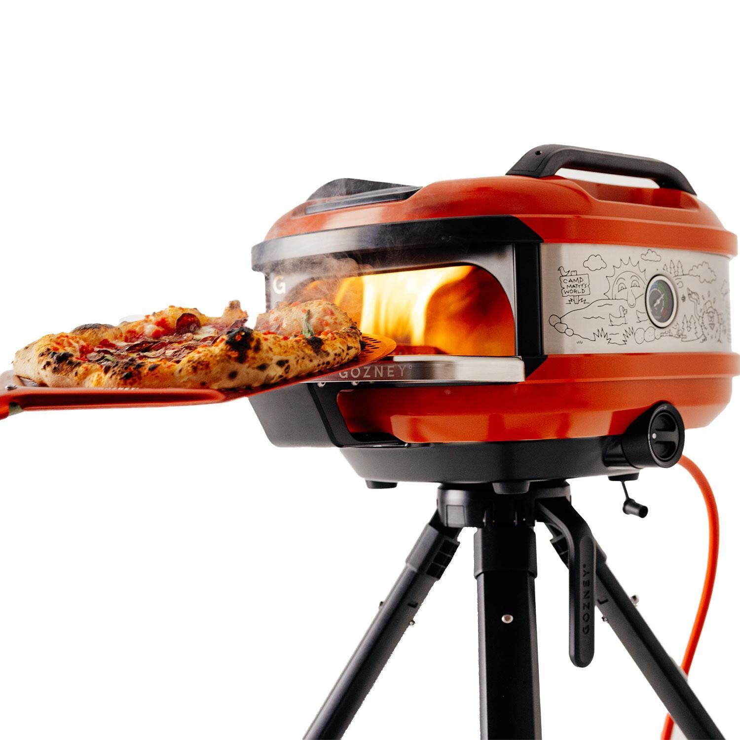 Matty Matheson x Gozney GTPOGUS1225 Limited-Edition Tread Portable Propane Pizza Oven - Orange - Inserting Prepped Pizza in Oven - Lifestyle thumbnail