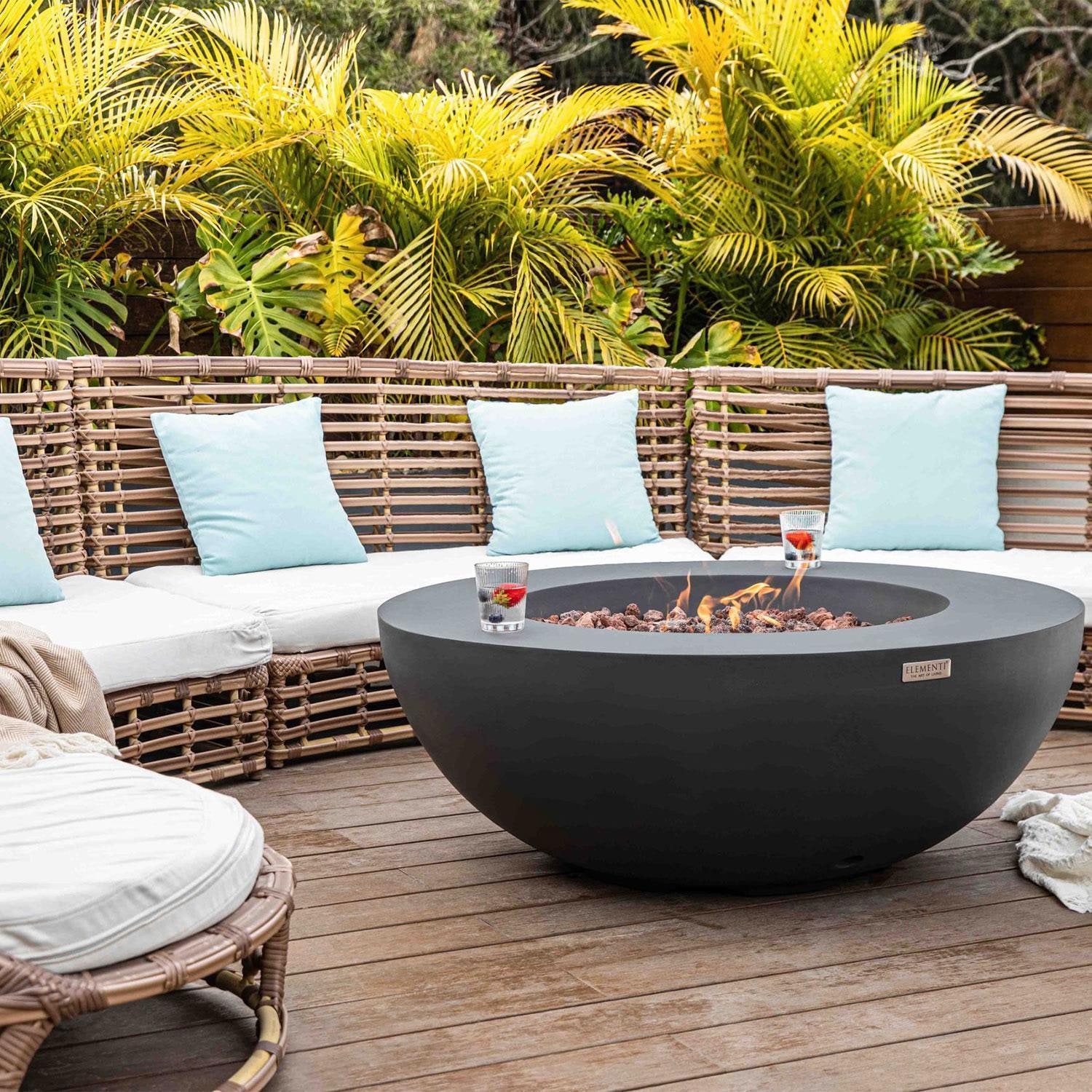 Lunar Bowl 40 Inch Round Concrete Natural Gas Fire Bowl in Dark Gray By Elementi - Back Patio - On - Lifestyle thumbnail