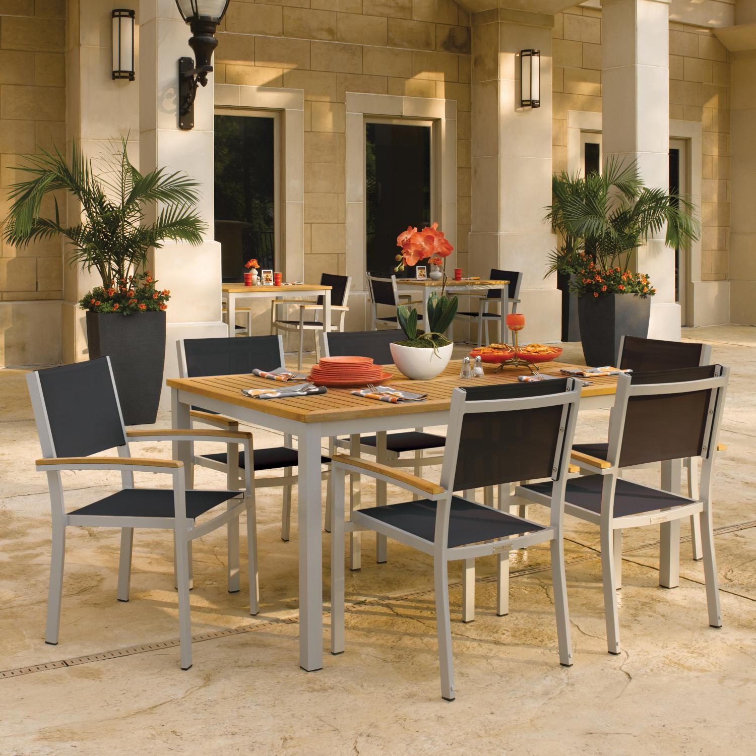 Oxford Garden Travira 7 Piece Flint Aluminum Patio Dining Set W/ Black Sling Armchairs & 63-Inch Rectangular Natural Tekwood Table thumbnail