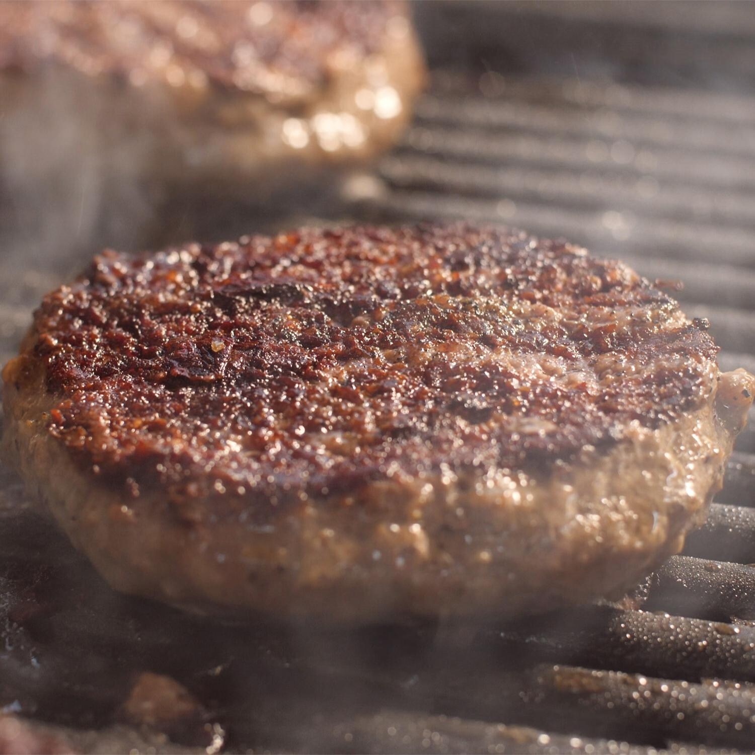 Coyote 18-Inch Built-In / Portable Electric Grill On Patio Post - Grilling Burgers Detail thumbnail