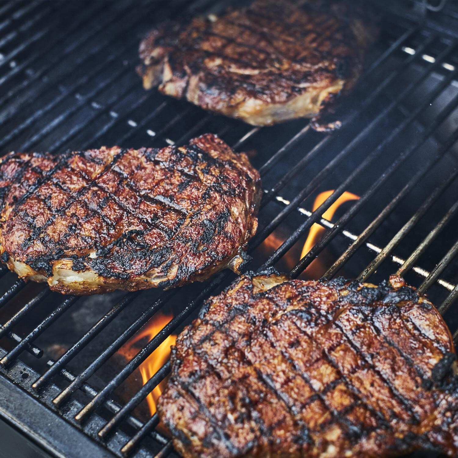 Weber 22510201 SmokeFire EX4 Gen 2 24-Inch Wi-Fi Enabled Wood Fired Pellet Grill - Grilling Steak - Detail thumbnail