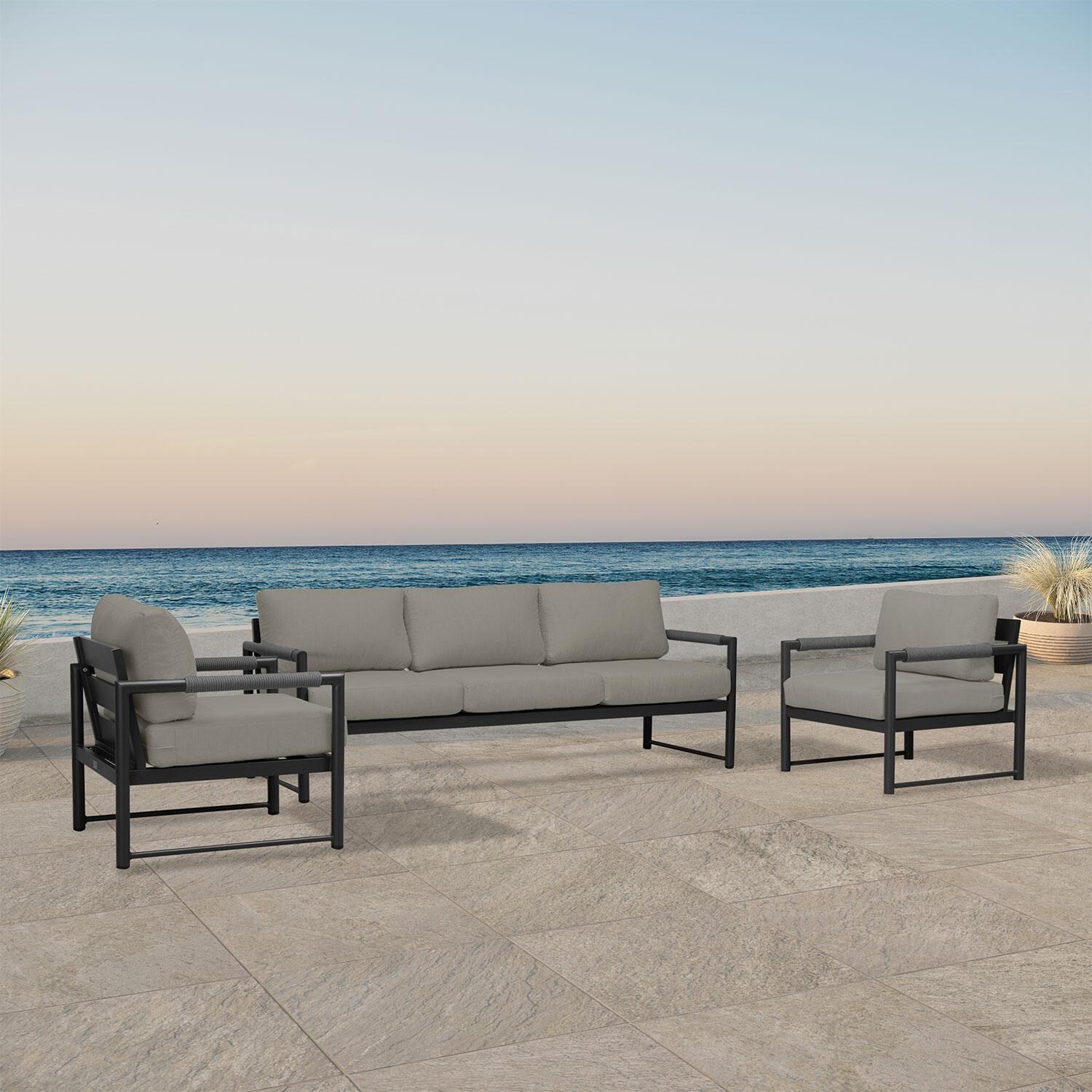 Lakeview AVEBAY-BK-CO-SET141-CC Avenue Bay Black/Carbon 3 Pc Sofa Club Chair Set - Canvas Charcoal - Angled On Patio - Lifestyle thumbnail