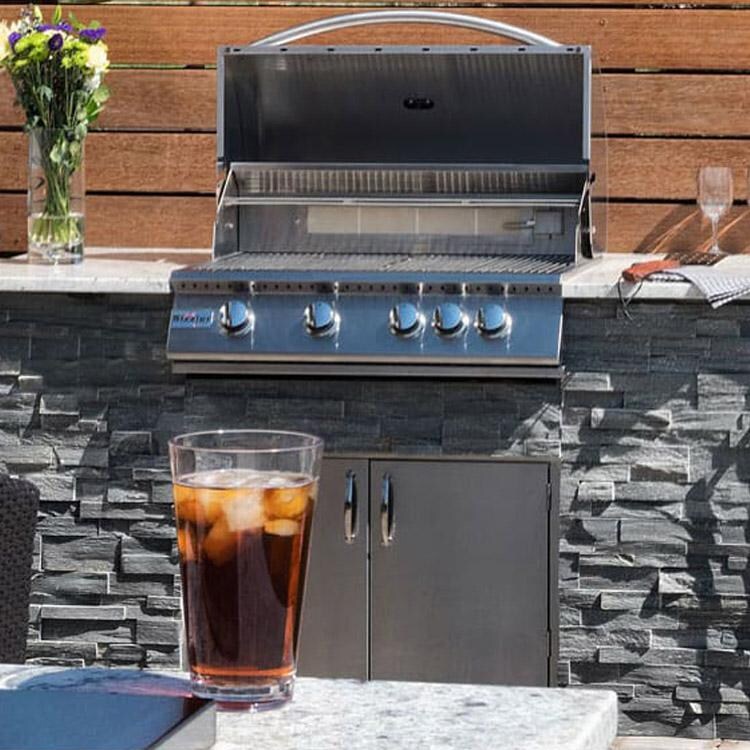 Grillnetics Adjustable Easy Outdoor Kitchen Frame Kit - Lifestyle View With Stone Finished Grill Cabinet & Access Doors thumbnail