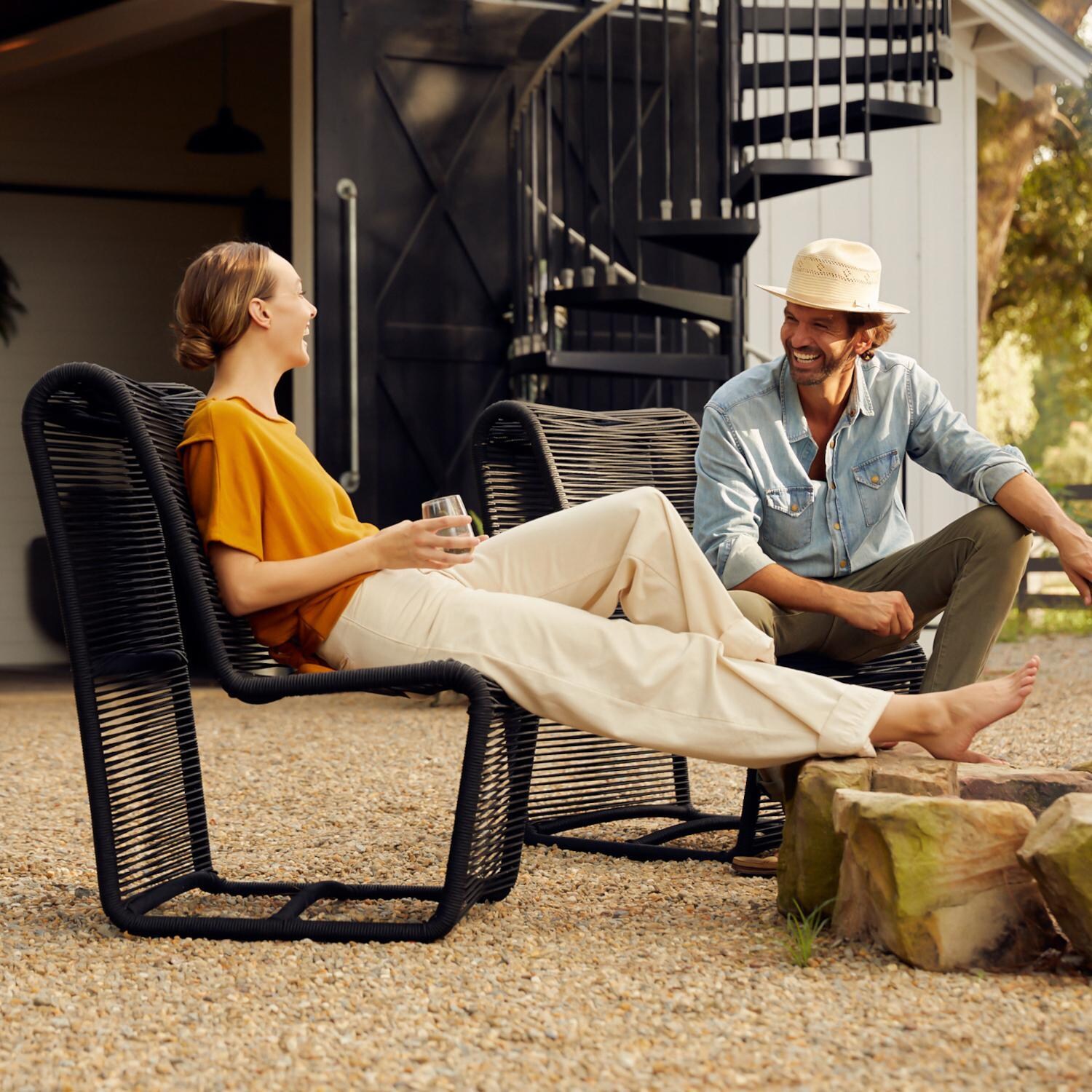 Teak + Table Breeze Olefin Rope Patio Armless Club Chair in Charcoal - Around the Firepit - Lifestyle thumbnail