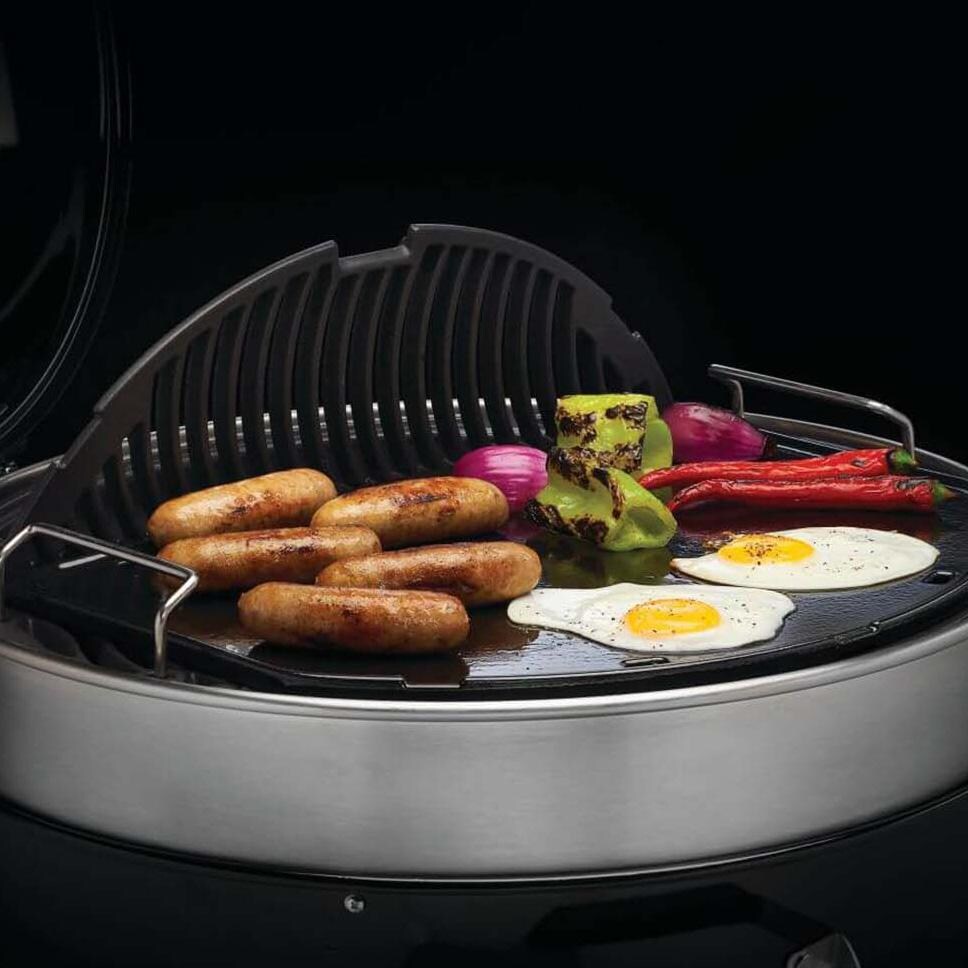 Napoleon  56083 Cast Iron Reversible Griddle for 22 inch Charcoal Grills - In Use w/ Grate Up - White Background thumbnail