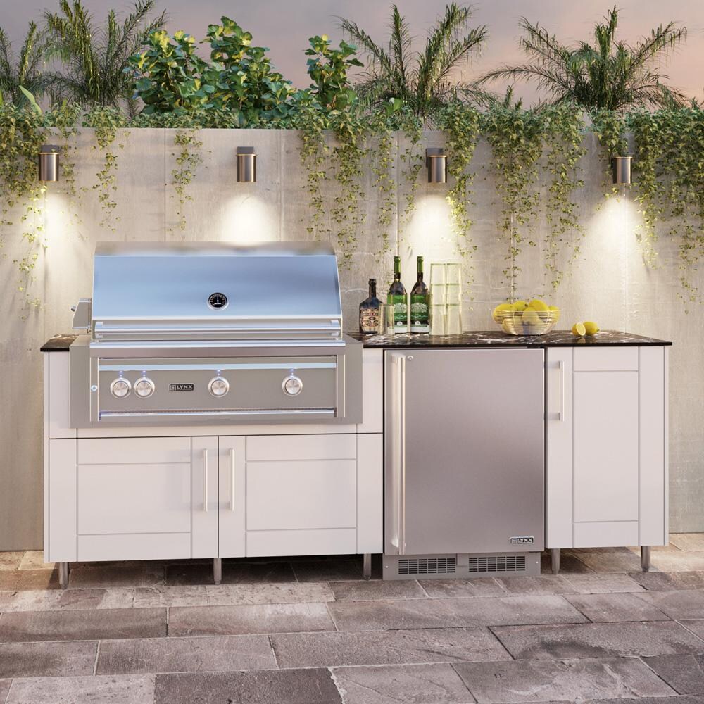 WeatherStrong Bimini 7 1/2 Ft Outdoor Kitchen Island w/ DCS Natural Gas Grill & Refrigerator in Shell White/Midnight Ice - On Patio - Lifestyle thumbnail