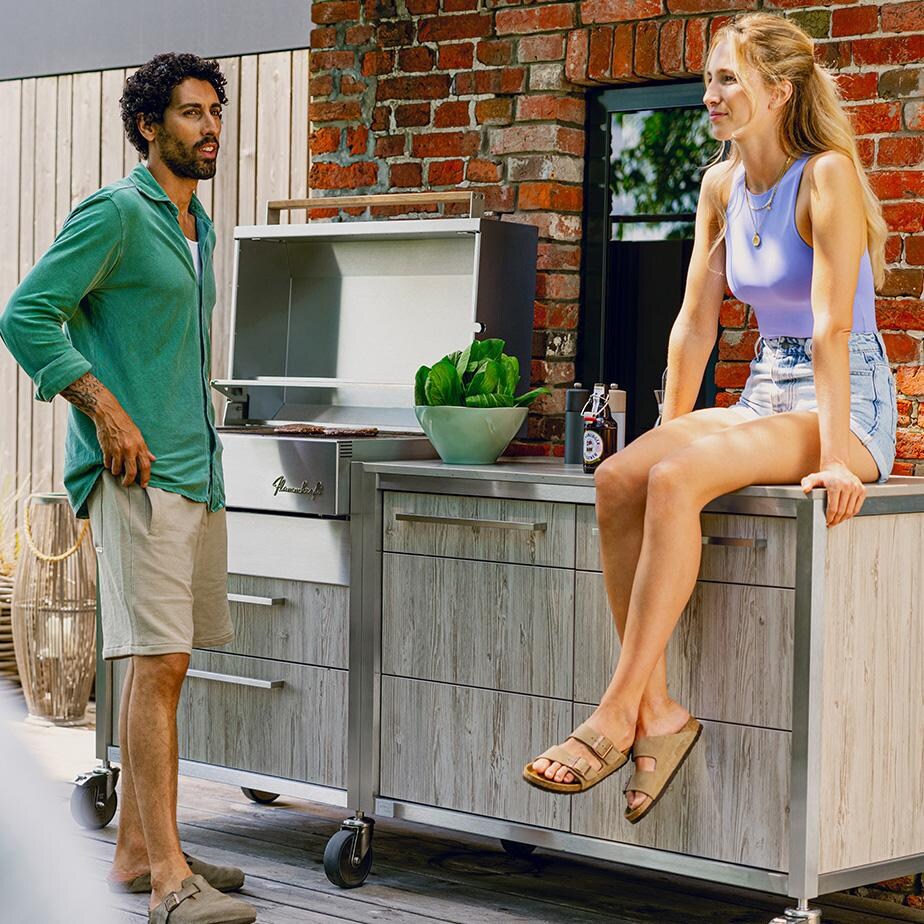 Burnout BBQ Modular Front-Lit Outdoor Kitchen Island w/ Flammkraft Model D Built-In Grill, Caso 4.4 Cu Ft. Refrigreator, Double Drawers, Propane Pullout, and Pullout Waste Bins- Cookout (Shown in Oak) - Lifestyle thumbnail