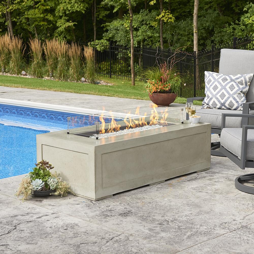 The Outdoor GreatRoom Company Cove Linear Gas Fire Pit Table - Lifestyle - Glass wind guard pictured is optional accessory thumbnail