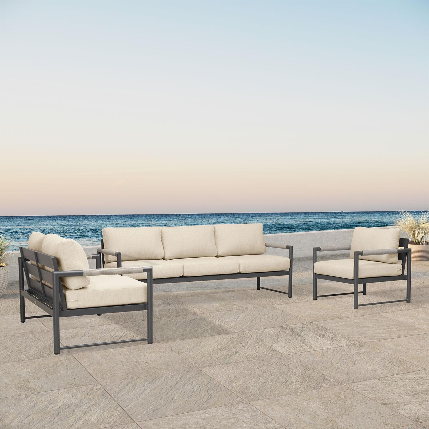 Lakeview AVEBAY-SL-PG-SET143-CF Avenue Bay Slate/Pebble Gray 3 Pc Sofa Loveseat Set - Canvas Flax - Angled On Patio - Lifestyle thumbnail