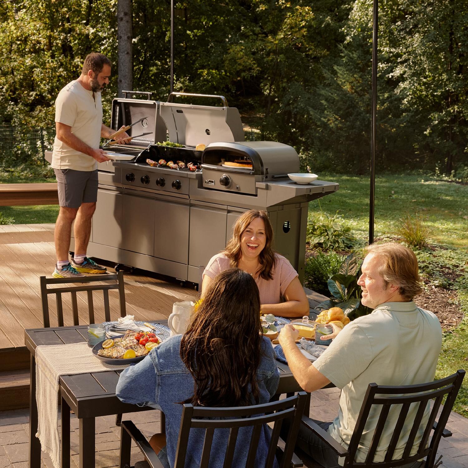 TYTUS TDT-BUN-065 Modular Trio w/ 4-Burner Gas Grill, Charcoal Grill & Gas Pizza Oven - Cooking on Patio - Lifestyle thumbnail